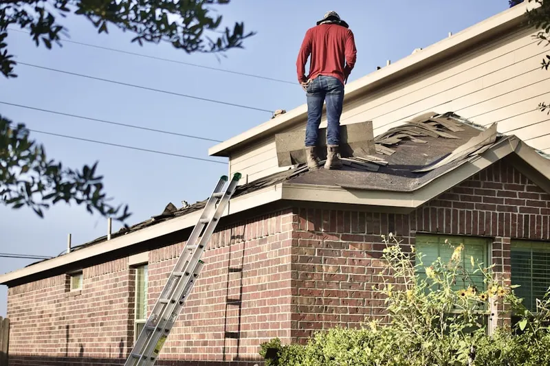 Professional roofer working on a residential roof in Charlestown Manor Beach